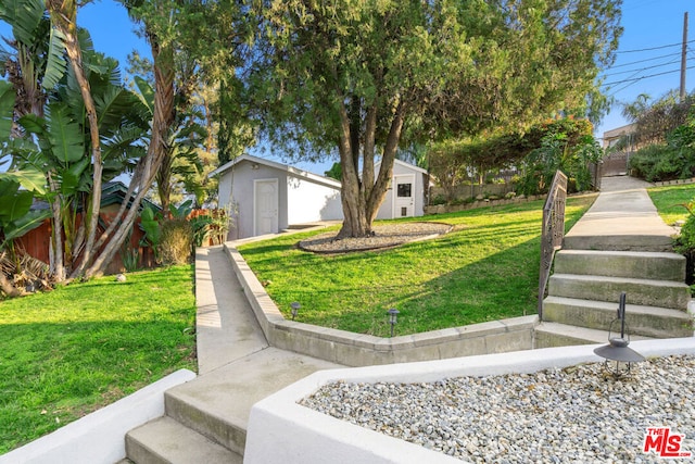 view of front facade with a storage unit and a front yard