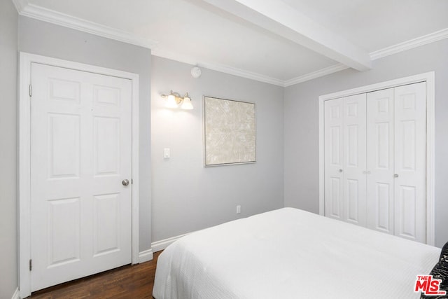 bedroom featuring beam ceiling, ornamental molding, dark hardwood / wood-style flooring, and a closet