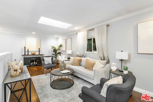 living room with crown molding, hardwood / wood-style flooring, and a skylight