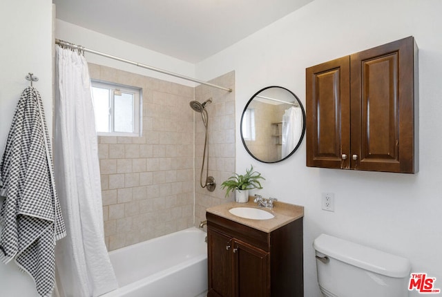 full bathroom featuring vanity, shower / bath combination with curtain, and toilet