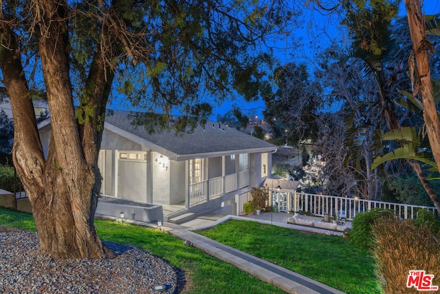 rear view of property featuring a yard