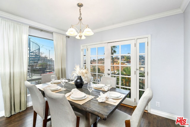 dining room featuring a notable chandelier, crown molding, dark wood-type flooring, and french doors