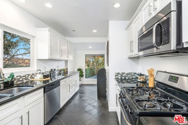 kitchen featuring white cabinetry, stainless steel appliances, sink, and plenty of natural light