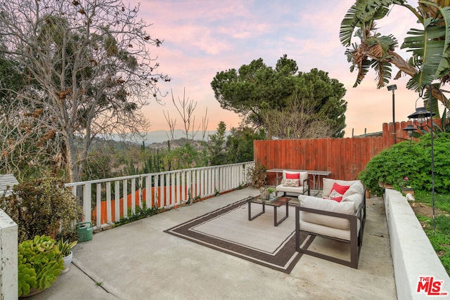 patio terrace at dusk with an outdoor hangout area