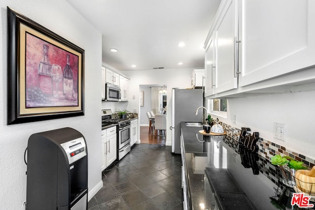 kitchen featuring white cabinetry, sink, and appliances with stainless steel finishes