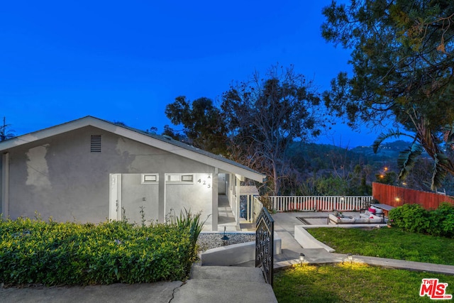 view of property exterior featuring a patio and a yard