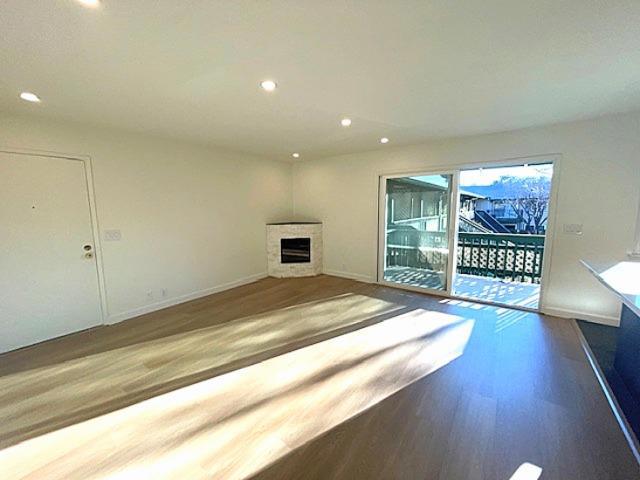 unfurnished living room with dark hardwood / wood-style floors