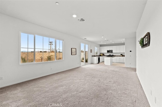 unfurnished living room with light carpet