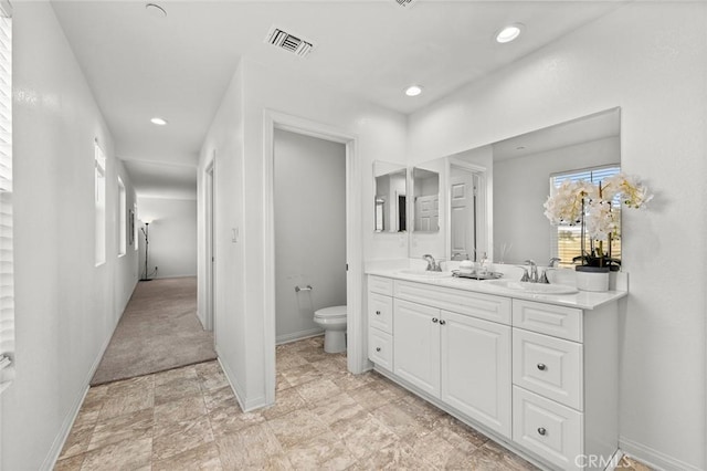 bathroom with vanity and toilet