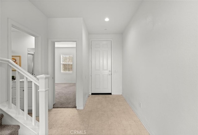 hallway featuring light carpet