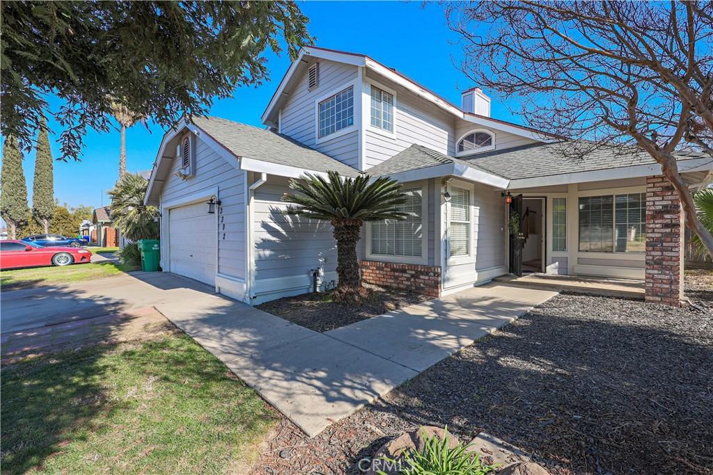 view of property with a garage and covered porch