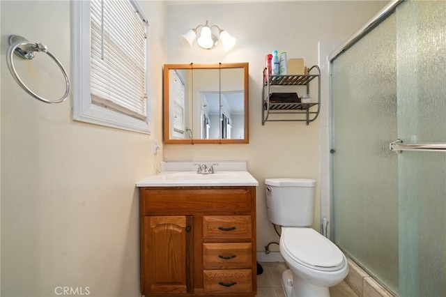 bathroom with vanity, toilet, a shower with shower door, and tile patterned flooring