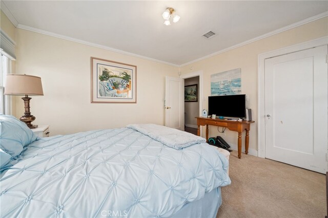 bedroom with light carpet and crown molding