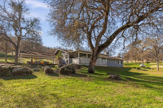 rear view of property featuring a lawn