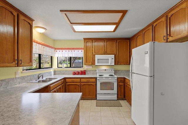 kitchen with light tile patterned flooring, white appliances, and sink