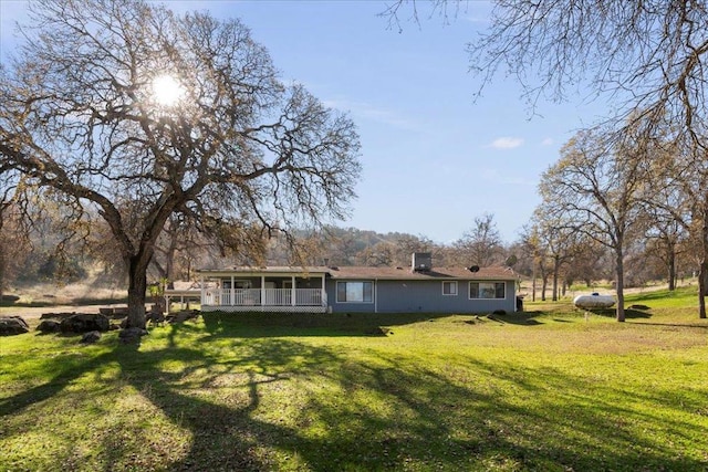 rear view of house with a yard