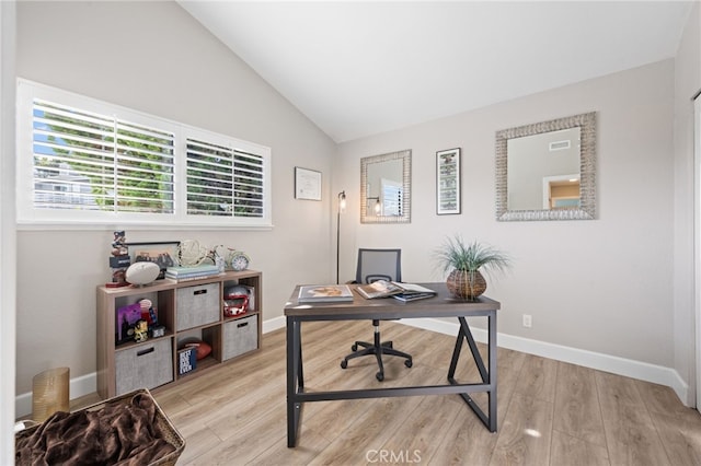 home office with light hardwood / wood-style flooring and vaulted ceiling