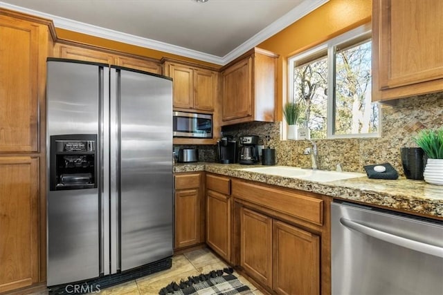 kitchen with sink, crown molding, light tile patterned floors, appliances with stainless steel finishes, and tasteful backsplash