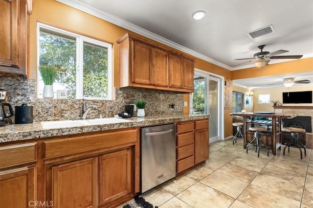 kitchen with dishwasher, sink, ornamental molding, and decorative backsplash