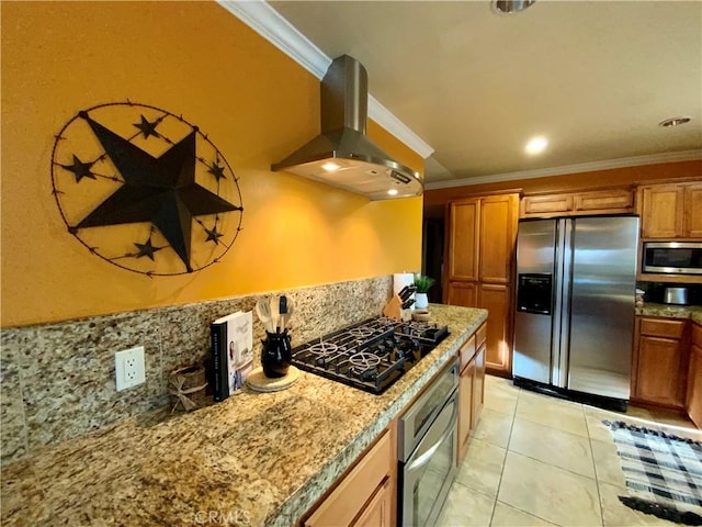 kitchen with light tile patterned floors, appliances with stainless steel finishes, ornamental molding, island exhaust hood, and light stone countertops