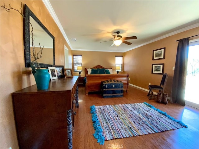 bedroom featuring wood-type flooring, ornamental molding, and ceiling fan