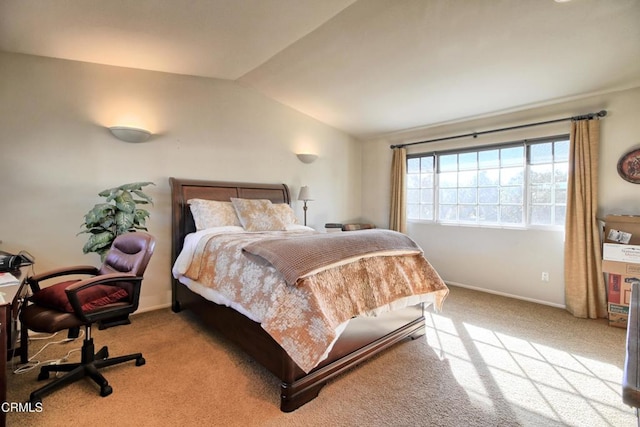 carpeted bedroom featuring lofted ceiling