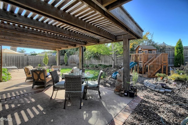 view of patio with a pergola and a playground