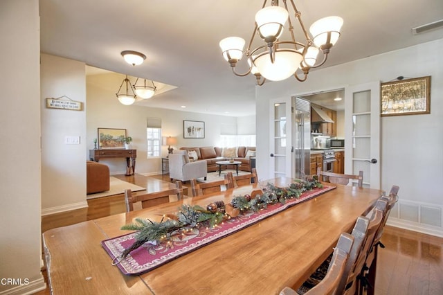 dining room featuring hardwood / wood-style flooring and an inviting chandelier