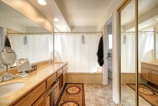 full bathroom featuring vanity, tile patterned floors, shower / bath combination with curtain, and toilet