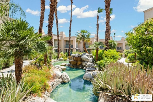 view of home's community featuring a garden pond