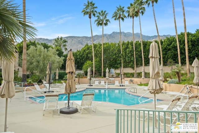 view of pool featuring a mountain view and a patio area