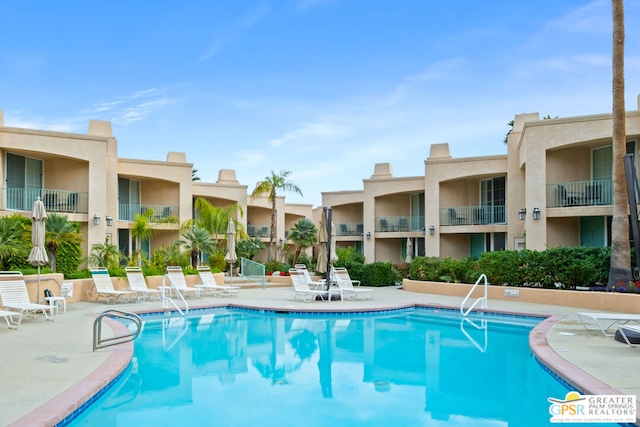 view of swimming pool featuring a patio area