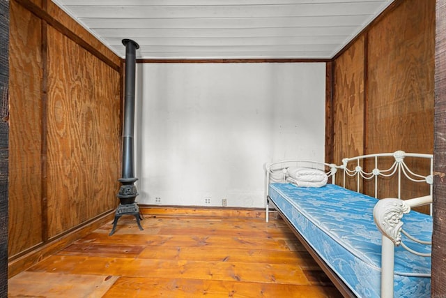 unfurnished bedroom featuring crown molding and hardwood / wood-style floors