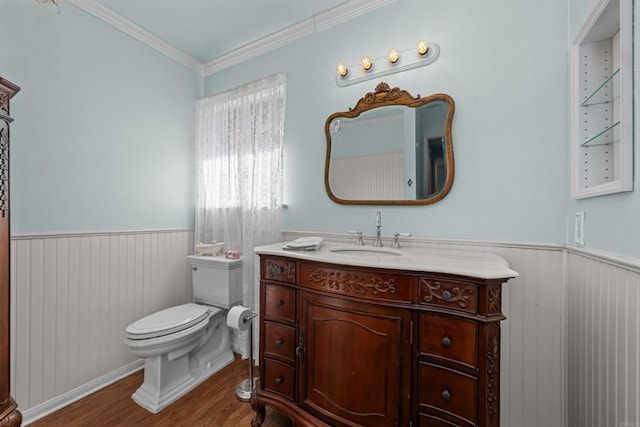 bathroom featuring vanity, hardwood / wood-style floors, ornamental molding, and toilet