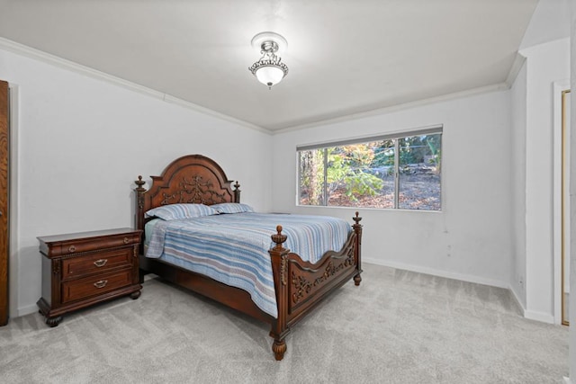 bedroom with ornamental molding and light carpet