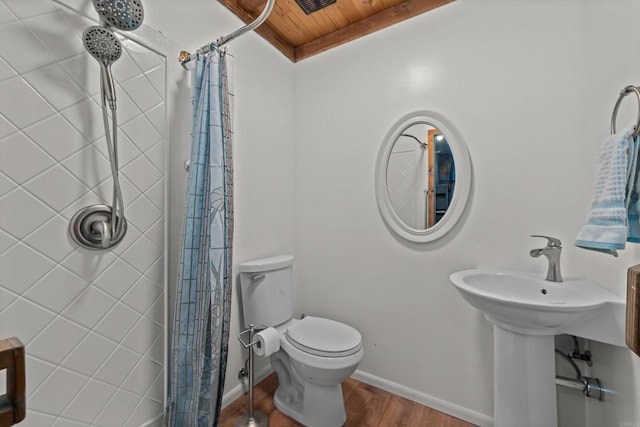 bathroom featuring hardwood / wood-style flooring, toilet, wood ceiling, and walk in shower