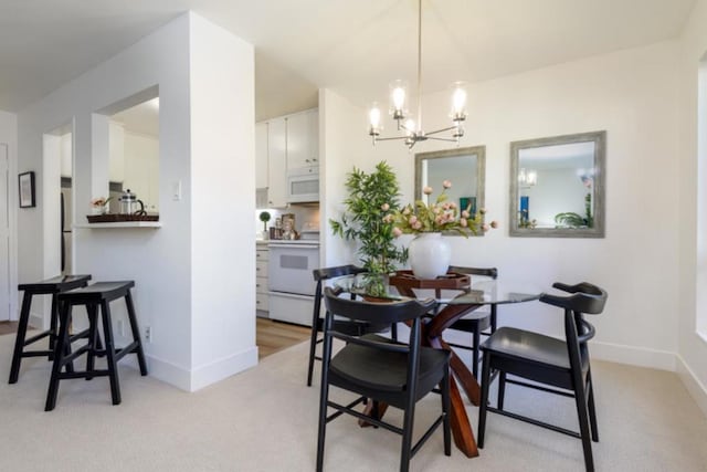 carpeted dining space with a chandelier