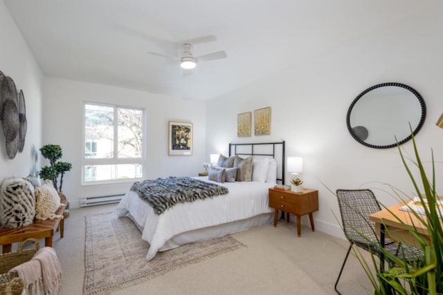 carpeted bedroom featuring a baseboard heating unit and ceiling fan