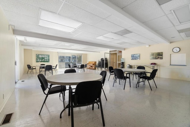 dining area featuring a paneled ceiling