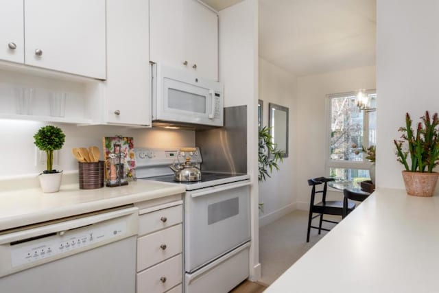 kitchen with white cabinetry and white appliances