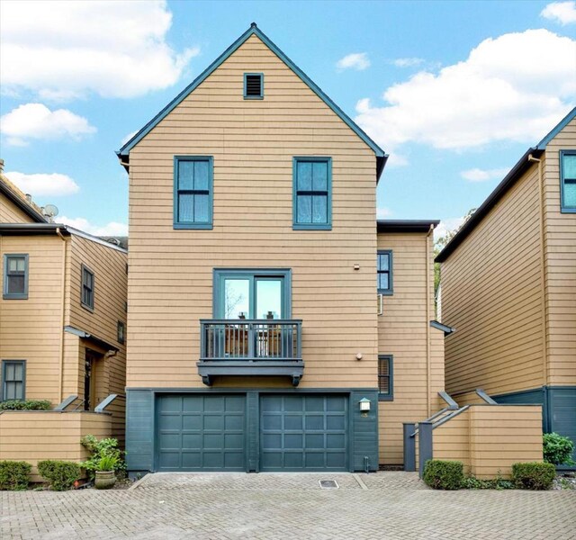 exterior space featuring a garage and a balcony