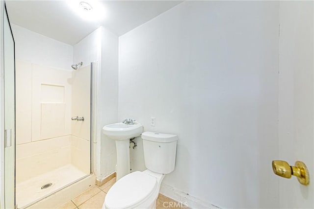 bathroom featuring a shower, sink, tile patterned floors, and toilet
