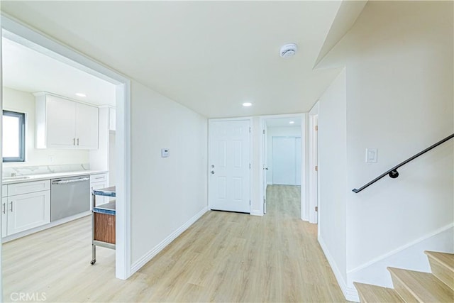 corridor with light hardwood / wood-style flooring