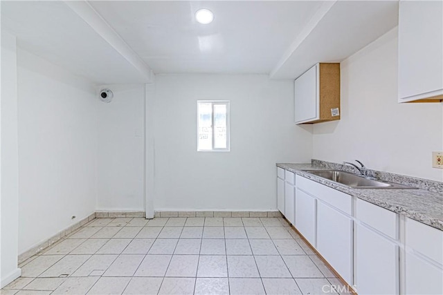 kitchen featuring sink and white cabinets