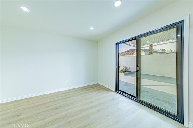 spare room featuring light hardwood / wood-style flooring