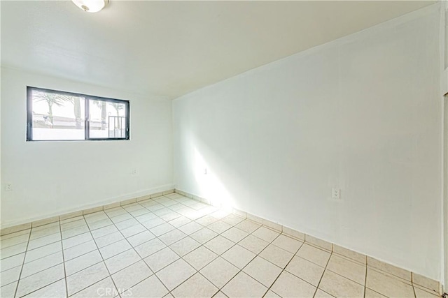 unfurnished room with light tile patterned floors