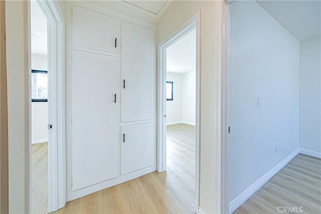 hallway featuring a healthy amount of sunlight and light wood-type flooring