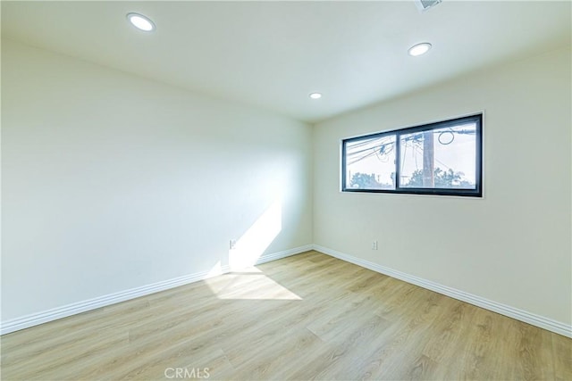 unfurnished room with light hardwood / wood-style flooring