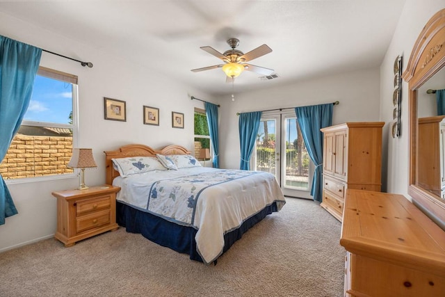 bedroom with light carpet, access to exterior, and ceiling fan