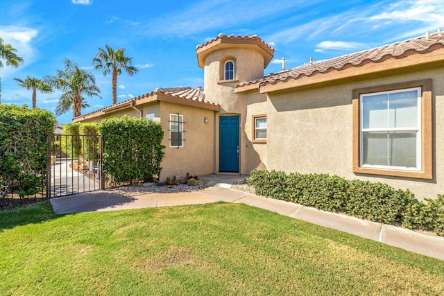 mediterranean / spanish-style home with a front lawn